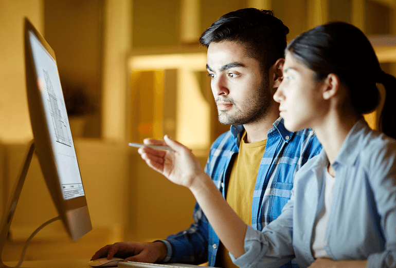 Team reviewing iGuide deliverables on a computer